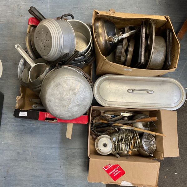 Vintage kitchenware lot with metal pans and baking trays.