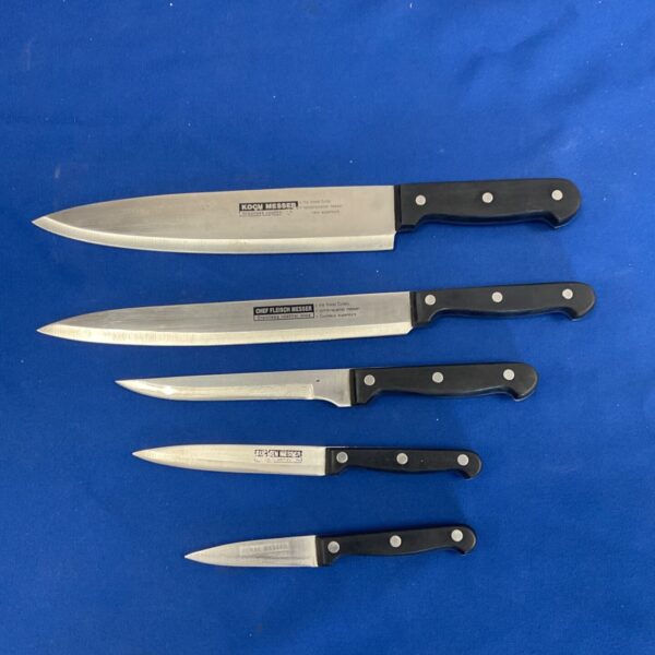 Koch Nesser professional chef knives set with black handles.