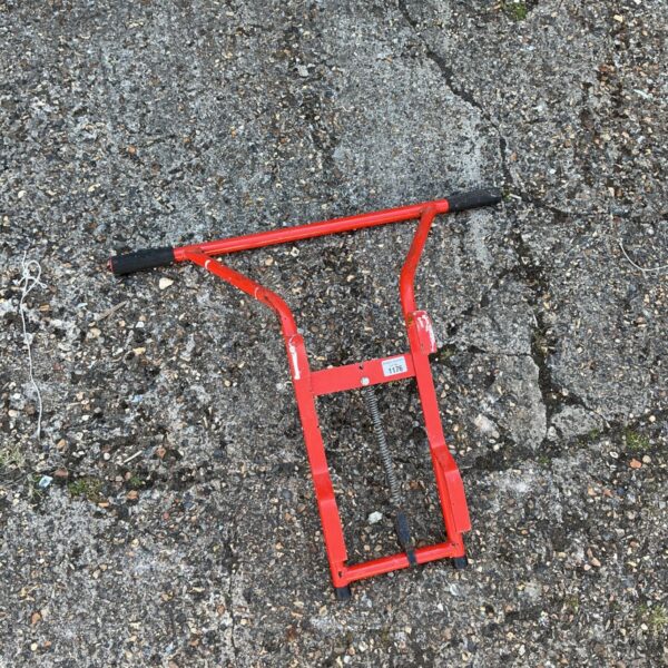 Red metal ladder standoff, Model 1176, for roof work.