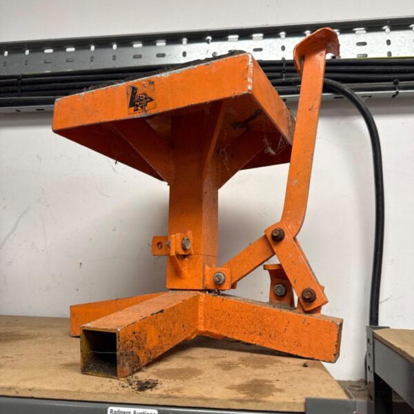 Orange LDracing motorcycle lift stand for rear wheel maintenance.
