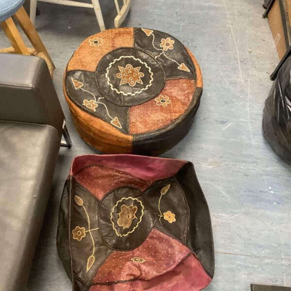 Close-up of a vintage leather footstool with patchwork design.