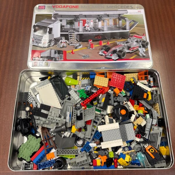Mixed Lego and Megabloks bricks in a McLaren Mercedes tin.