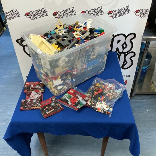 Large crate of mixed Lego bricks and figures for building.