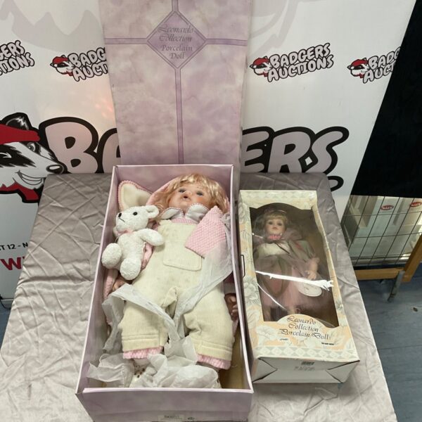 Two Leonardo Collection porcelain dolls in their original boxes.
