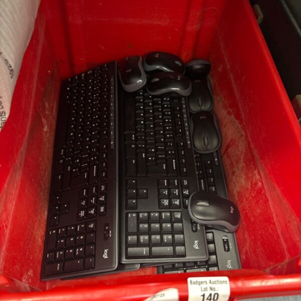 Bulk lot of Logitech keyboards and mice for computer use.