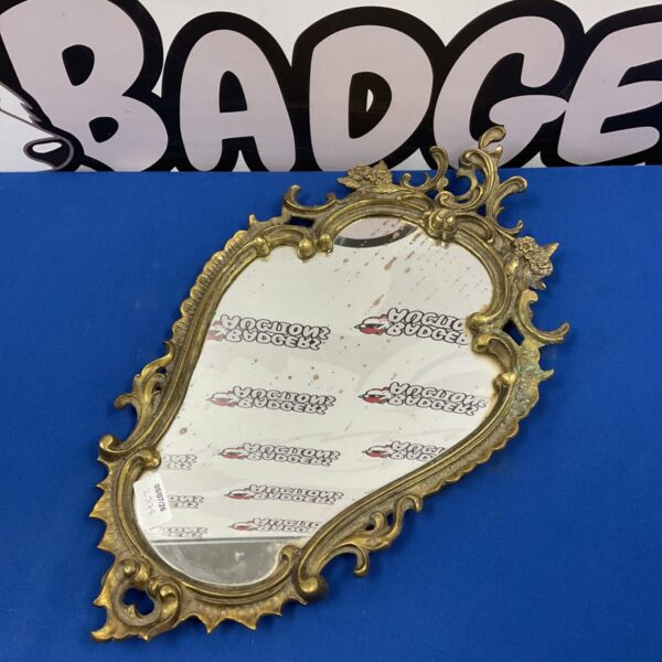 Antique French brass wall mirror 21” length from tip of frame to bottom
