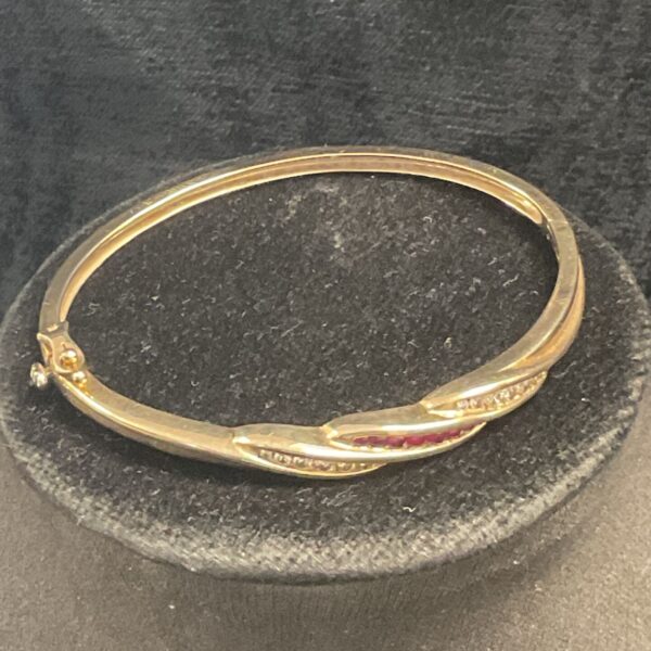 Hallmarked 9ct .375 Gold Hinged Bracelet set with two rows of seven diamonds either side of a row of seven rubies 13g