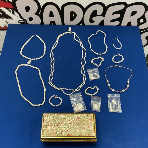 Tin of pearl and faux pearl necklaces most with silver clasps