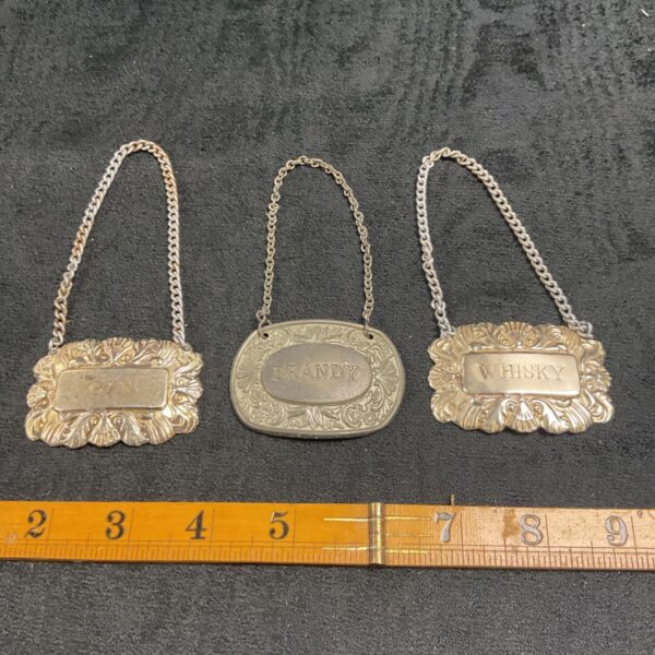three vintage silver plated decanter, labels, brandy, whiskey gin