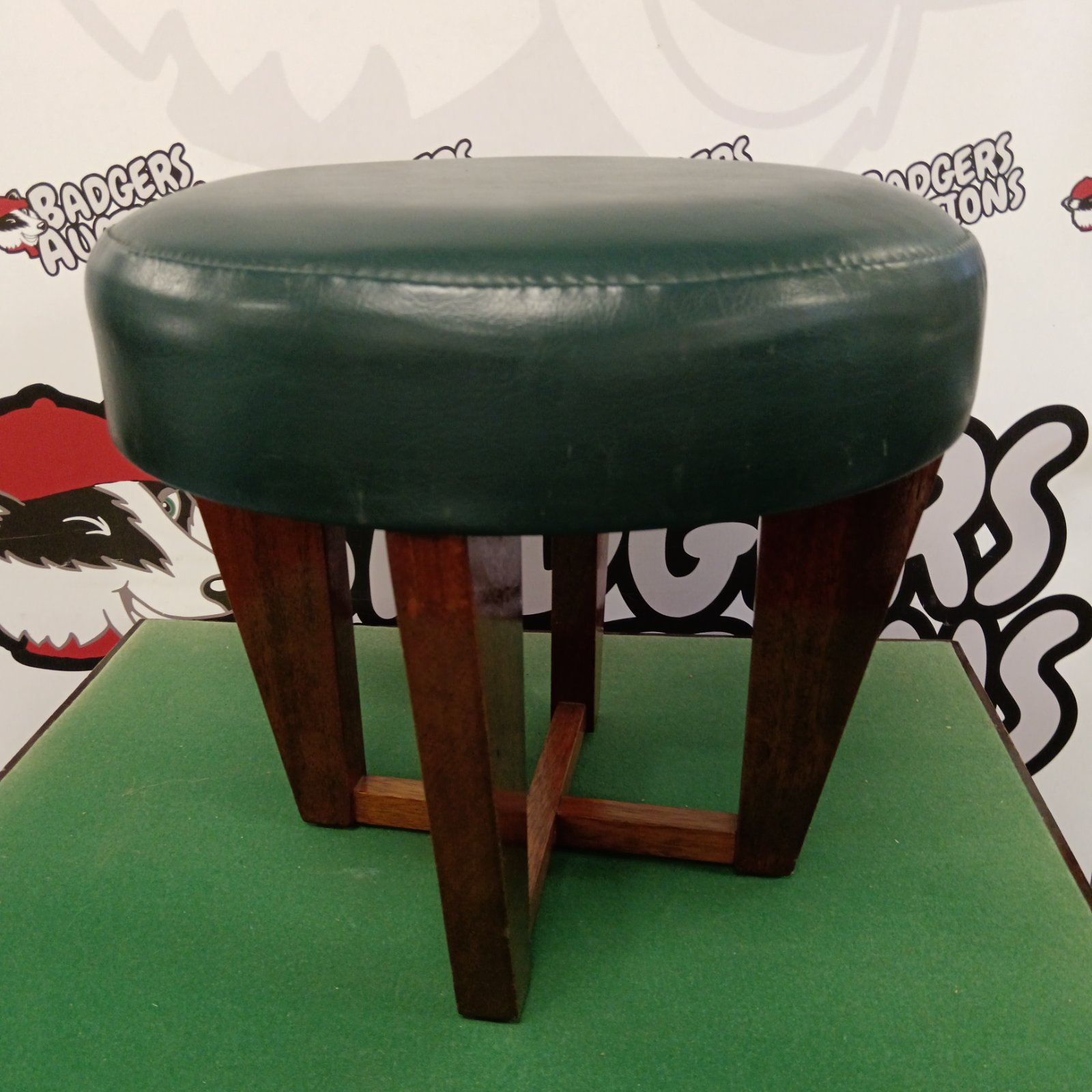 Oak framed footstool with green leather top
