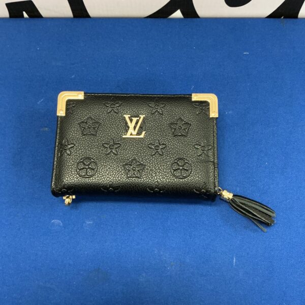 Patterned Louis Vuitton style purse with tassel detail.