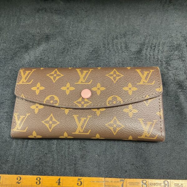 Front view of a Louis Vuitton style monogram wallet.