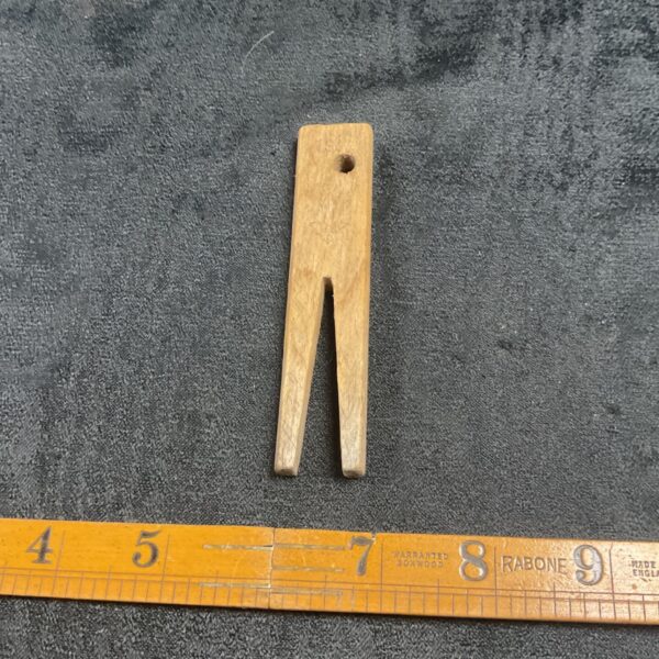 Vintage Luftwaffe clothes peg displayed with a ruler for scale.