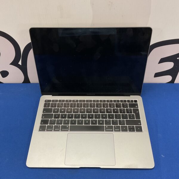 Silver Apple Macbook Air laptop with distorted screen.