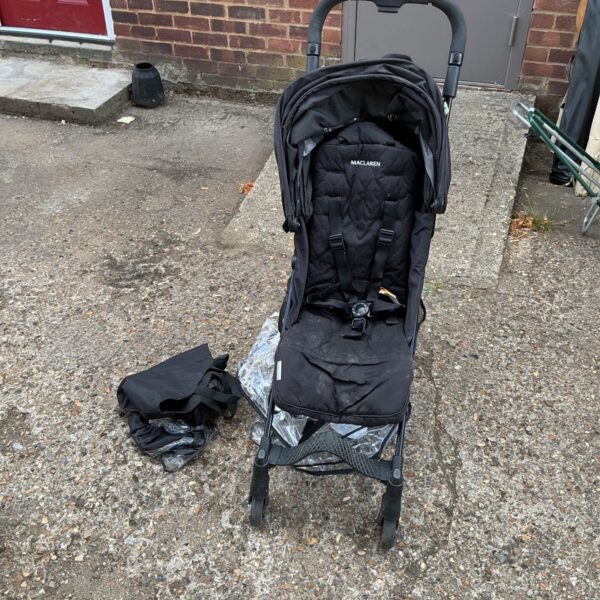 Vintage Maclaren pushchair in used condition, side view.