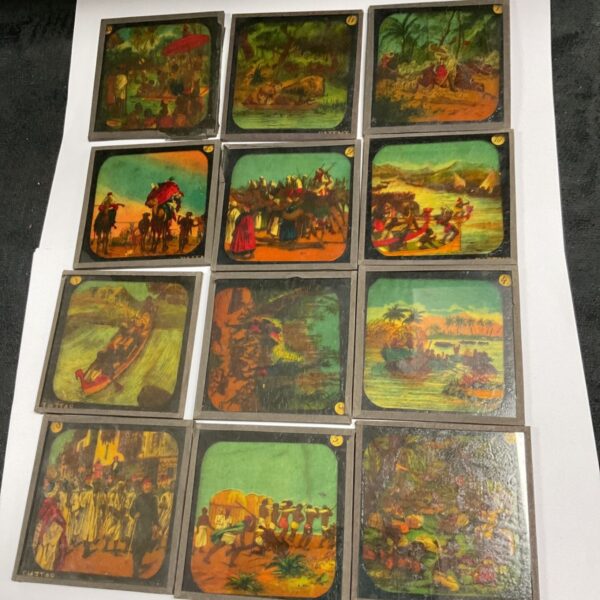 Group of vintage magic lantern colour slides, collectible antique optical devices.