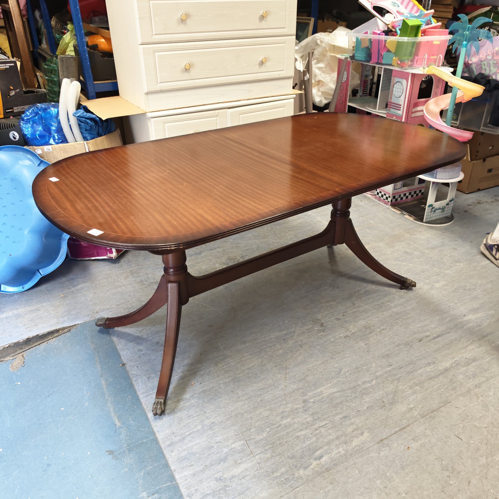 Reproduction mahogany extending dining table with claw feet.