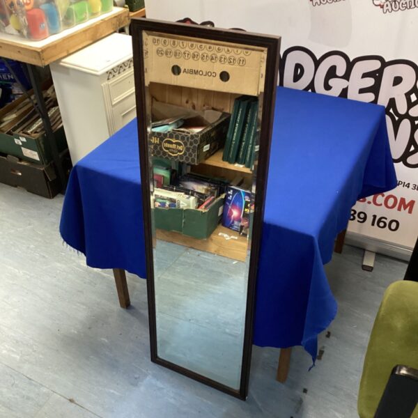 Antique mahogany framed rectangular mirror for wall display.