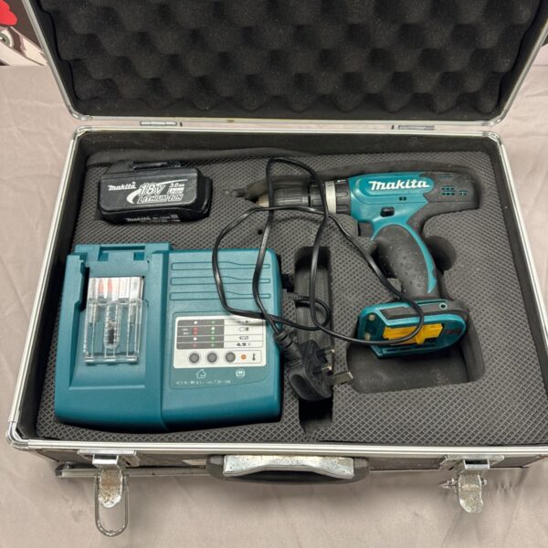 Makita cordless drill with battery and charger in damaged case.