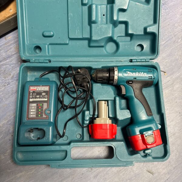 Open Makita cordless drill set showing drill, charger, and batteries.