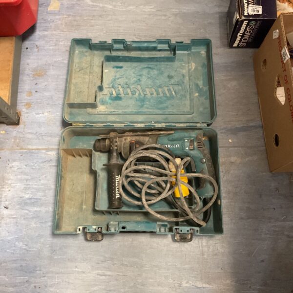 Open Makita HR2230 rotary hammer drill showing internal components.