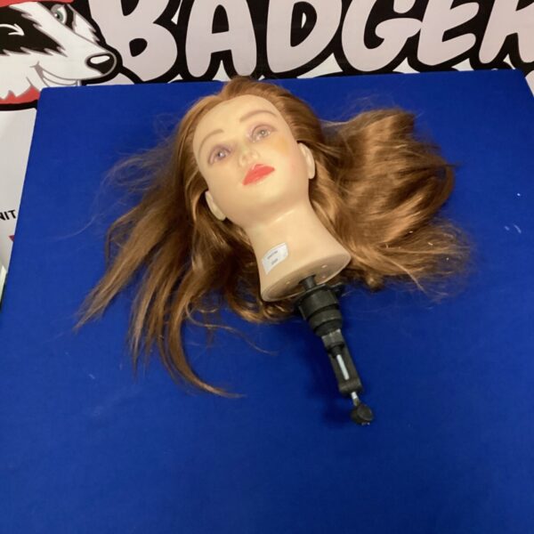 Blonde mannequin head with desk clamp for hair styling practice.
