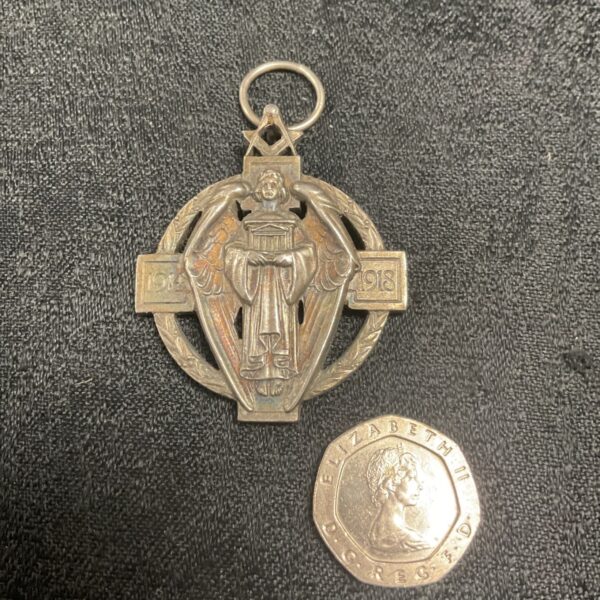 Antique silver Masonic jewel from 1914-1918 with detailed design.