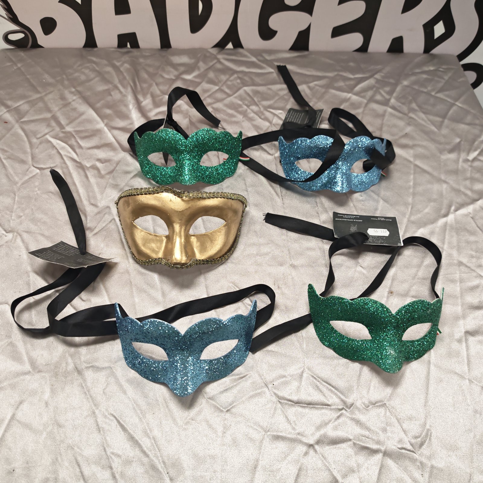 Lot of five gold and green glitter masquerade masks.