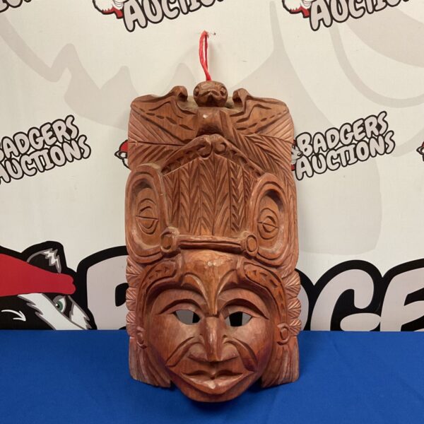Hand carved wooden Mayan wall hanging mask with detailed features.