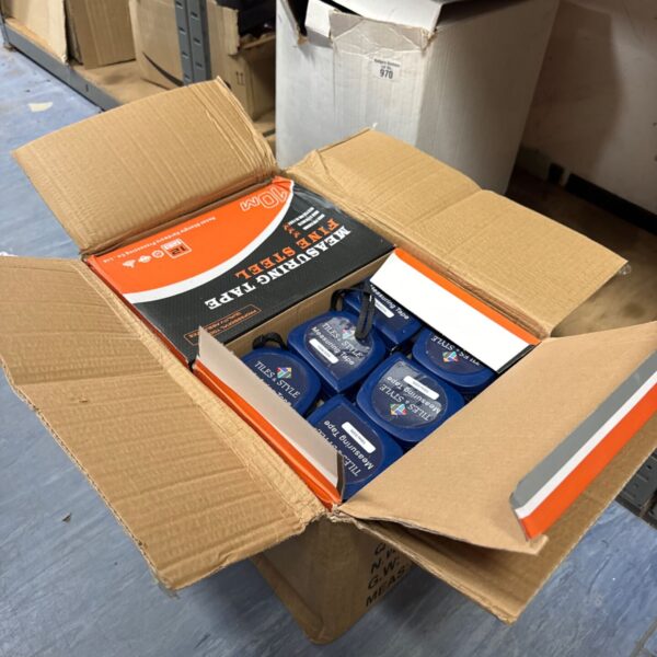 New tiles and 10m measuring tape in cardboard box.