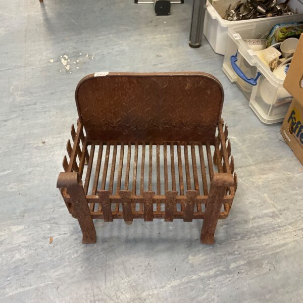 Vintage metal dog fire grate for fireplace hearth.