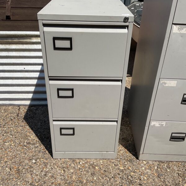 Vintage metal filing cabinet with three drawers for office storage.