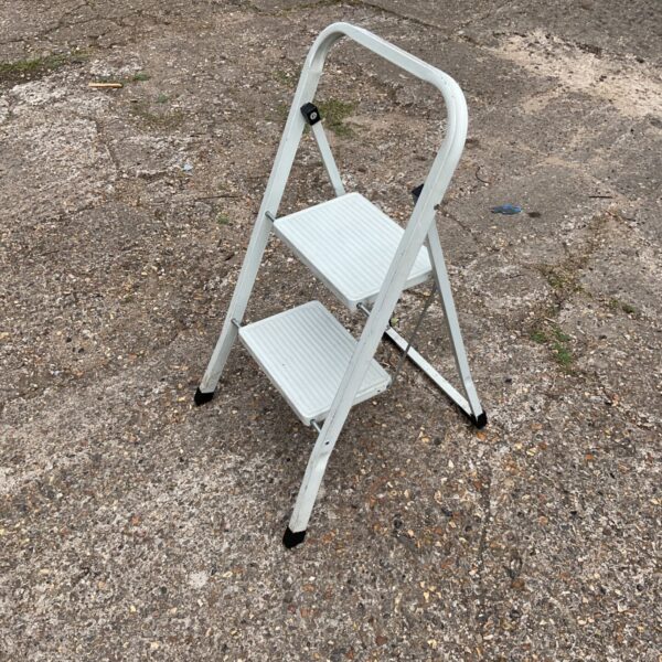 Vintage metal kitchen step stool, folded for storage.