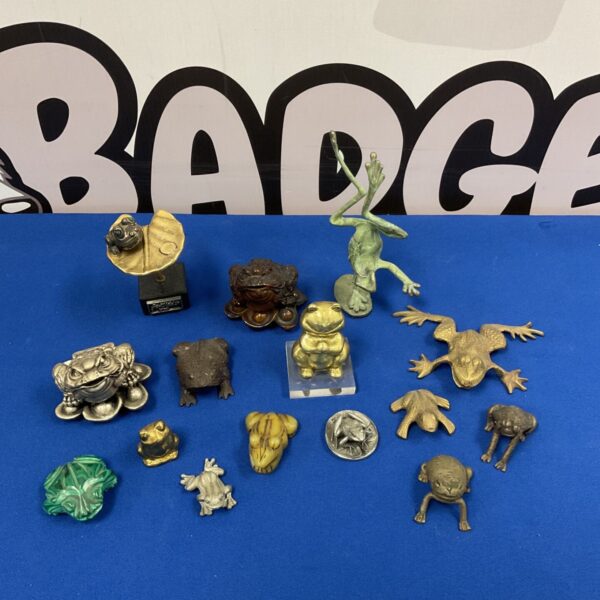 Collection of vintage metal and stone frog figurines and sculptures.