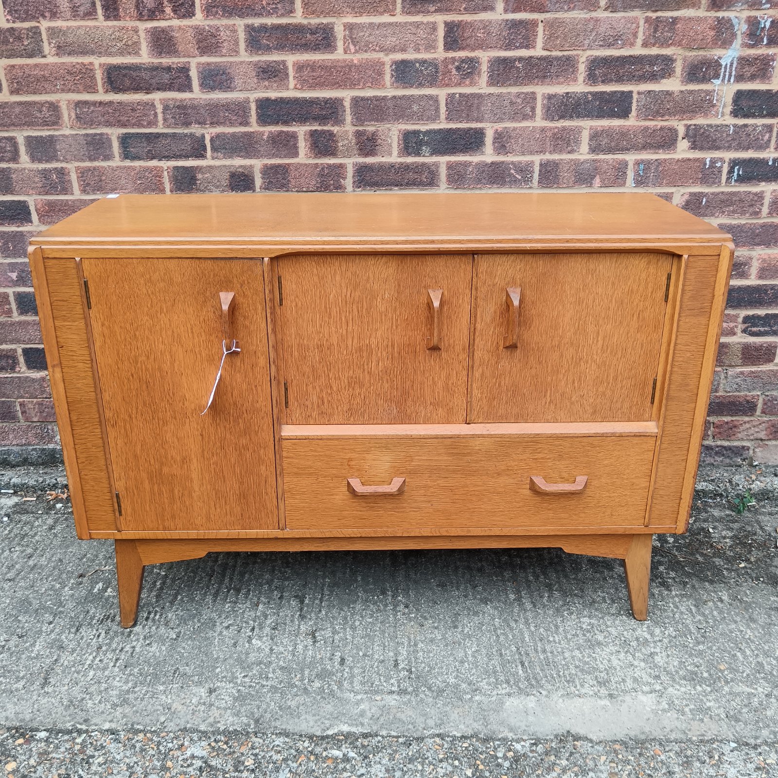 Vintage mid century sideboard with blonde wood finish and tapered legs.