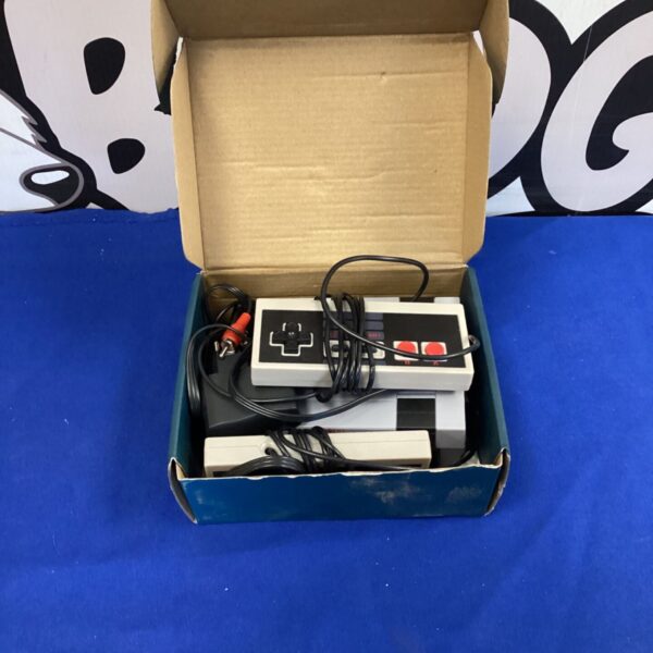 Mini game console in box with controller and games.