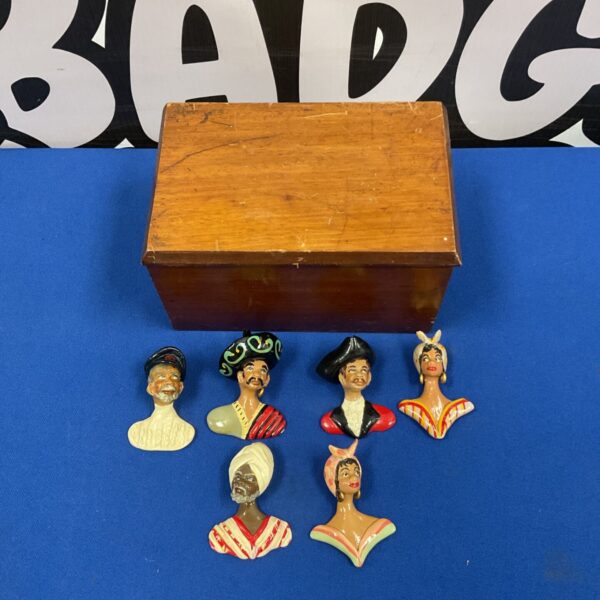 Vintage set of six miniature character busts in wooden box.