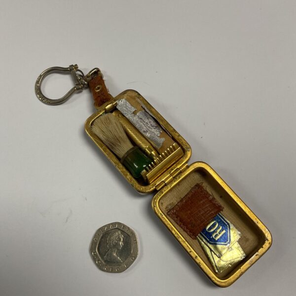 Vintage miniature shaving set with keyring attachment.