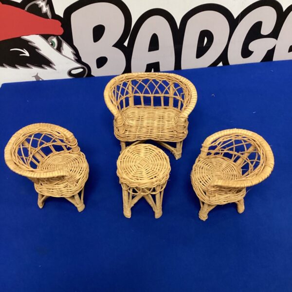Close-up of miniature wicker chair, vintage dollhouse furniture.