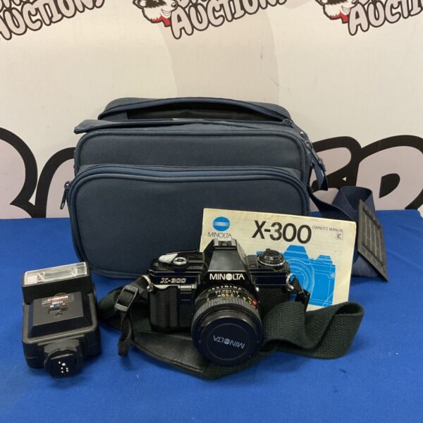 Vintage Minolta X-300 35mm film camera with Cobra MD210 flash unit.
