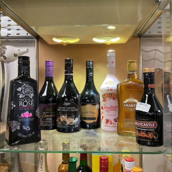 Mixed alcohol lot featuring Tequila Rose, Baileys, and Amaretto bottles.