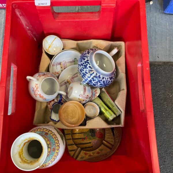 Mixed china lot with teacups, saucers, and decorative porcelain pieces.