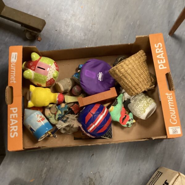 Tray of mixed children's toys and a ceramic piggy bank.