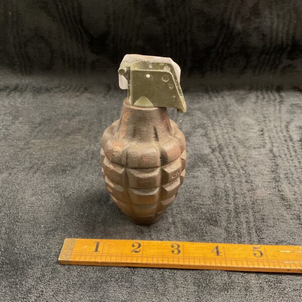 Vintage deactivated MK2 hand grenade, a collectible piece of US military history.