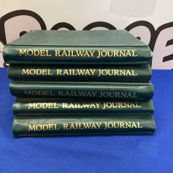 Stack of five vintage model railway journals.