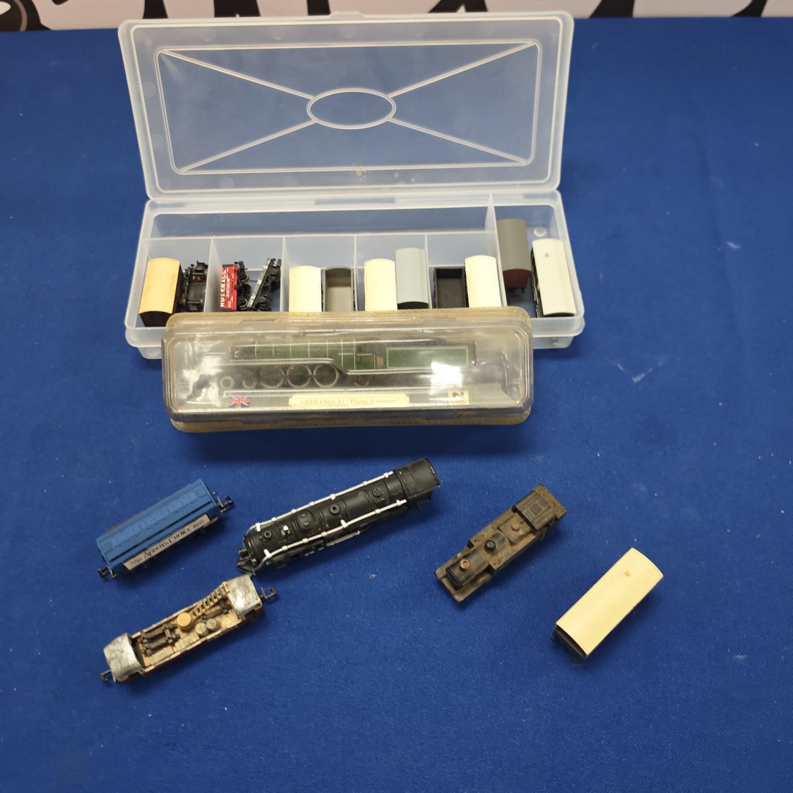 Vintage OO gauge model train set with carriages in storage box.