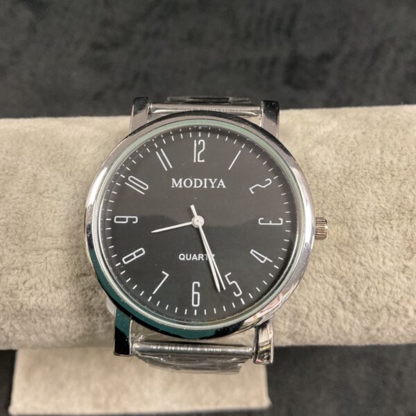 Silver Modiya quartz wristwatch with black strap.