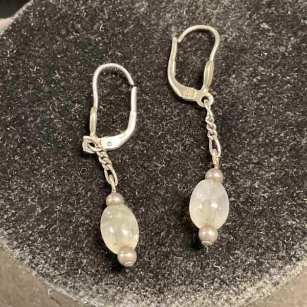 Silver drop earrings with luminous moonstone and amethyst accents.