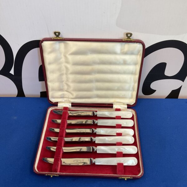 Antique set of six mother of pearl butter knives with silver plated blades.