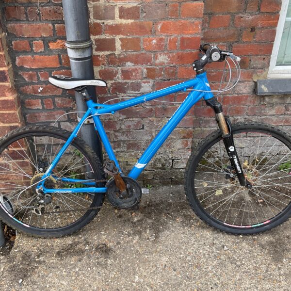 Blue Muddyfox Mayhem mountain bike with front suspension.